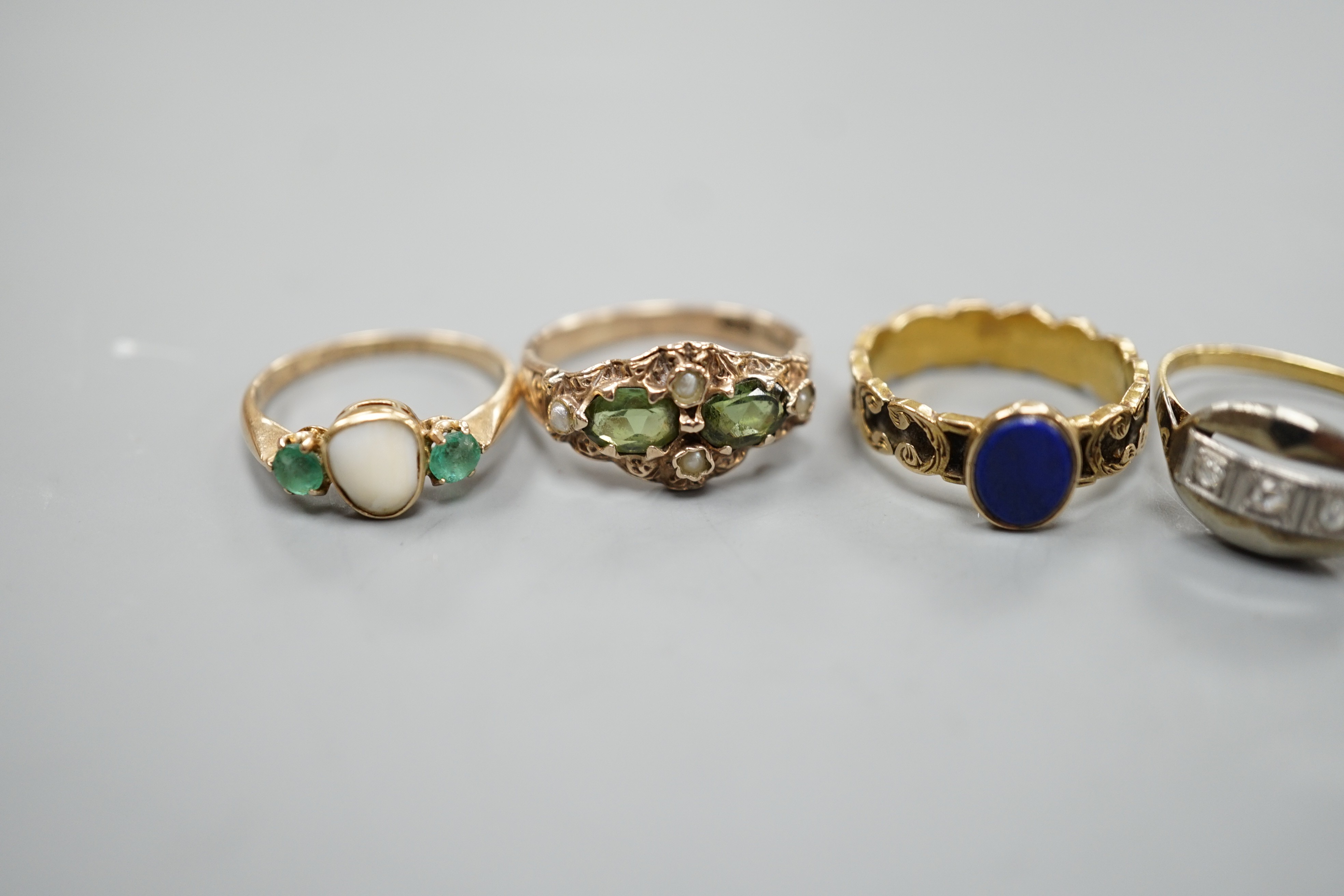 Five assorted early 20th century and later gem set rings, including 15ct white opal and enamel size O, gross weight 2.6 grams, a 585 emerald and white stone ring, gross 2 grams and three others including 9ct gold, gross